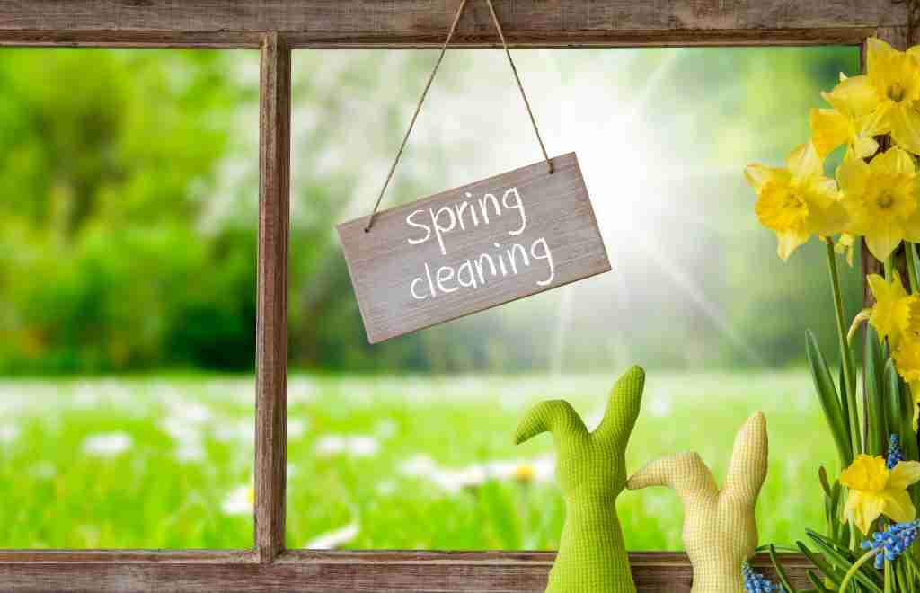 Sign on a window that says "spring cleaning"