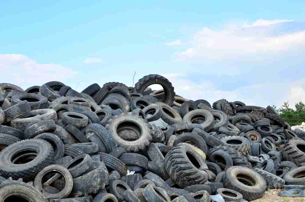 A landfill of used, worn, and broken tires