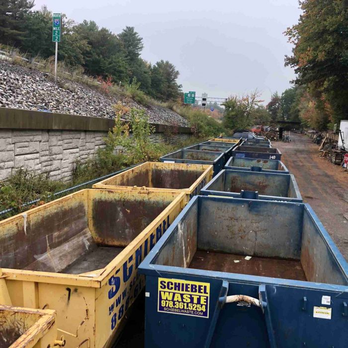 Schiebel waste dumpster stacked side by side together