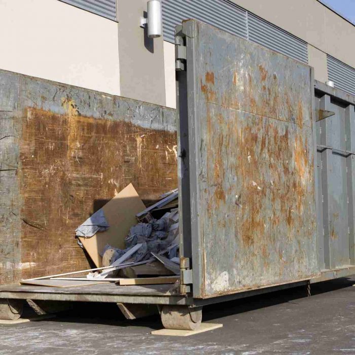 A large gray dumpster filled with trash