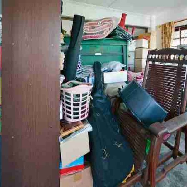 A cluttered room filled with old items and furniture