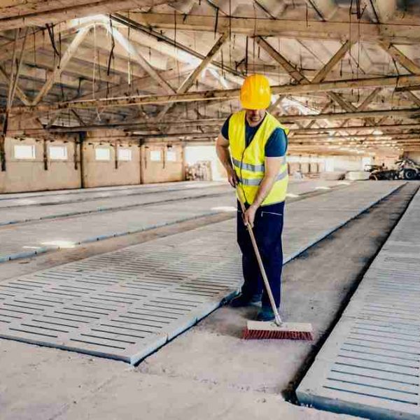 Construction worker sweeping on the jobsite